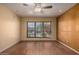 Well-lit living room showcases wood floors, neutral walls, and a ceiling fan at 4226 E Jojoba Rd, Phoenix, AZ 85044