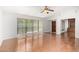 Well-lit living room featuring wood floors, expansive windows, and an open doorway to a den or study at 4226 E Jojoba Rd, Phoenix, AZ 85044