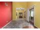 Spacious living area with tile flooring, red accent wall, and sliding glass door at 4226 E Jojoba Rd, Phoenix, AZ 85044