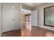 Bright living room with wood floors, white doors, and light colored walls at 4226 E Jojoba Rd, Phoenix, AZ 85044