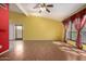 Spacious living room featuring hardwood floors, a vaulted ceiling, and large windows that let in natural light at 4226 E Jojoba Rd, Phoenix, AZ 85044