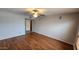 Spacious living room with ceiling fan, wood flooring, and neutral paint at 4226 E Jojoba Rd, Phoenix, AZ 85044