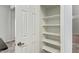 Pantry with a white door, open shelves, and ample storage at 4226 E Jojoba Rd, Phoenix, AZ 85044