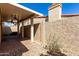 Covered patio with brick flooring, ceiling fans, stucco walls, and desert landscaping at 4226 E Jojoba Rd, Phoenix, AZ 85044