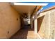 Covered patio with brick flooring, ceiling fans, stucco walls, and desert landscaping at 4226 E Jojoba Rd, Phoenix, AZ 85044