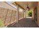 Covered patio with ceiling fans, brick flooring, and desert landscaping at 4226 E Jojoba Rd, Phoenix, AZ 85044