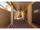 Covered patio with brick flooring, ceiling fan, stucco walls, and desert landscaping at 4226 E Jojoba Rd, Phoenix, AZ 85044