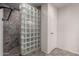 Walk-in shower featuring decorative tile and a glass block partition at 4226 E Jojoba Rd, Phoenix, AZ 85044