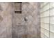 Close-up of a tiled walk-in shower with a built-in shelf at 4226 E Jojoba Rd, Phoenix, AZ 85044