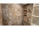 Shower area features a recessed shelf and glass blocks for privacy and light at 4226 E Jojoba Rd, Phoenix, AZ 85044