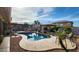 Backyard pool area featuring a covered patio, seating, lush landscaping and a clear blue sky at 4312 W Olney Ave, Laveen, AZ 85339