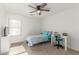 Bright bedroom features a ceiling fan, window with blinds, and a workspace area at 43554 W Sunland Dr, Maricopa, AZ 85138