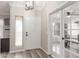 Welcoming foyer featuring wood-look flooring, stylish light fixture, and glass-paneled French doors at 43554 W Sunland Dr, Maricopa, AZ 85138