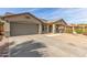 Attractive single-level house with a two-car garage, gravel yard, and covered front porch at 43554 W Sunland Dr, Maricopa, AZ 85138