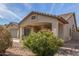 Front exterior featuring desert-style landscaping and a covered porch, set in a residential neighborhood at 43554 W Sunland Dr, Maricopa, AZ 85138