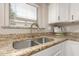 Granite countertops complement stainless steel sink and fixtures in this kitchen view at 43554 W Sunland Dr, Maricopa, AZ 85138