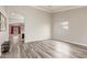 Spacious living room featuring laminate wood flooring, natural light, and neutral paint at 43554 W Sunland Dr, Maricopa, AZ 85138