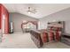 Spacious main bedroom featuring a ceiling fan and an en-suite bathroom at 43554 W Sunland Dr, Maricopa, AZ 85138