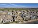 Expansive aerial view of a residential neighborhood showcasing well-maintained homes and green spaces at 4498 E Bethena St, Gilbert, AZ 85295