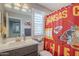 Bathroom featuring a shower curtain with sports team design and a large vanity mirror at 4498 E Bethena St, Gilbert, AZ 85295