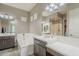 Bathroom with dual sinks, a soaking tub, and modern lighting for a luxurious experience at 4498 E Bethena St, Gilbert, AZ 85295