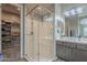 Bathroom featuring a large glass shower, double sink vanity, and large walk-in closet at 4498 E Bethena St, Gilbert, AZ 85295