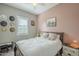 Bedroom featuring a comfortable bed, stylish decor, and plenty of natural light from the window at 4498 E Bethena St, Gilbert, AZ 85295