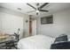 Cozy bedroom with a ceiling fan, a desk, and a view to the hallway at 4498 E Bethena St, Gilbert, AZ 85295