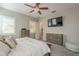 Bedroom featuring a ceiling fan, plantation shutters, tv, and a large bed at 4498 E Bethena St, Gilbert, AZ 85295