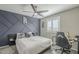 Stylish bedroom with a custom accent wall, ceiling fan, and a well-lit desk area at 4498 E Bethena St, Gilbert, AZ 85295