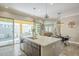 Spacious kitchen with island, stainless steel sink, sliding doors to patio, and dining area visible at 4498 E Bethena St, Gilbert, AZ 85295