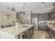 Modern kitchen featuring a large island, stainless steel appliances, dark wood cabinets, and wood-style flooring at 4498 E Bethena St, Gilbert, AZ 85295