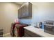 Laundry room featuring front-load washer and dryer and upper cabinets for ample storage at 4498 E Bethena St, Gilbert, AZ 85295