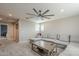 Comfortable living room featuring a large sofa, ceiling fan, and bright windows at 4498 E Bethena St, Gilbert, AZ 85295