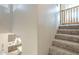 Carpeted staircase with a safety gate overlooking the modern kitchen with stainless steel appliances at 4498 E Bethena St, Gilbert, AZ 85295