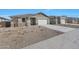 Single-story home showing the front yard, two-car garage and desert landscaping at 4552 W Willow Run --, San Tan Valley, AZ 85144