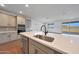 Kitchen island featuring a stainless steel sink, quartz countertop, dark hardware, and gray cabinets at 4552 W Willow Run --, San Tan Valley, AZ 85144