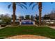 Picturesque backyard featuring a rectangular pool with fountains, lush landscaping, and mature palm trees at 5016 E Butler Dr, Paradise Valley, AZ 85253