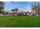 Sprawling backyard featuring green lawn, mature trees, and a swimming pool at 5016 E Butler Dr, Paradise Valley, AZ 85253