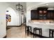 Stylish bar area with dark wood cabinetry, marble countertops, and pendant lighting at 5016 E Butler Dr, Paradise Valley, AZ 85253