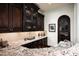 Luxurious bar area with granite countertops, custom cabinetry, and elegant decor at 5016 E Butler Dr, Paradise Valley, AZ 85253