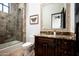 Charming bathroom with a shower-tub combination and granite-topped dark wood vanity, radiating warmth at 5016 E Butler Dr, Paradise Valley, AZ 85253