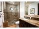 Bathroom featuring travertine stone floors, a walk-in shower with tile surround, and a granite vanity with a sink at 5016 E Butler Dr, Paradise Valley, AZ 85253