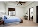 Serene bedroom with blue bedding, soft lighting, and a woven bench at the foot of the bed at 5016 E Butler Dr, Paradise Valley, AZ 85253