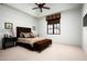 Comfortable bedroom featuring warm tones, a plush bed, and ample natural light from the window at 5016 E Butler Dr, Paradise Valley, AZ 85253