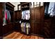 Custom closet with dark wood cabinets, ample hanging space, and shelves for storage, enhancing organization and style at 5016 E Butler Dr, Paradise Valley, AZ 85253