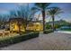 Elegant home exterior showcasing manicured landscaping, brickwork, and inviting outdoor lighting at twilight at 5016 E Butler Dr, Paradise Valley, AZ 85253