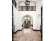 Grand foyer boasts high ceilings, a wrought iron railing, and travertine floors at 5016 E Butler Dr, Paradise Valley, AZ 85253