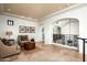 Hallway featuring travertine floors, a decorative iron railing, and arched doorways, creating an elegant transition space at 5016 E Butler Dr, Paradise Valley, AZ 85253