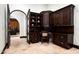 Elegant home office featuring custom dark wood cabinetry and shelving, perfect for a sophisticated workspace at 5016 E Butler Dr, Paradise Valley, AZ 85253